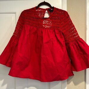 Vici red blouse with knit detail and bell sleeves.